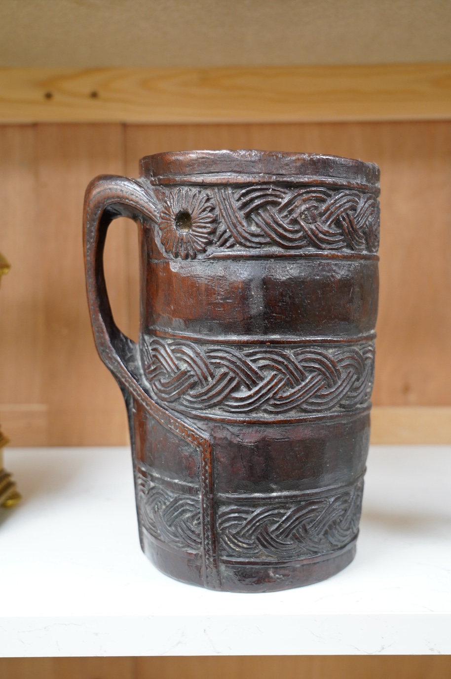 A Scandinavian carved wood tankard, lacking lid, 24cm. Condition - commensurate with age